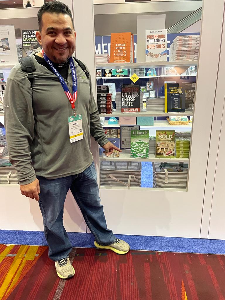 Robert Cowes pointing to his book "All Lines In" in a bookstore display