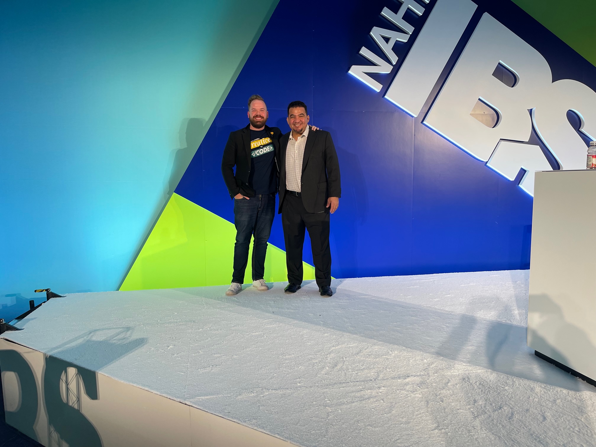 Robert Cowes and Brandon Barelmann on stage at IBS 2023 