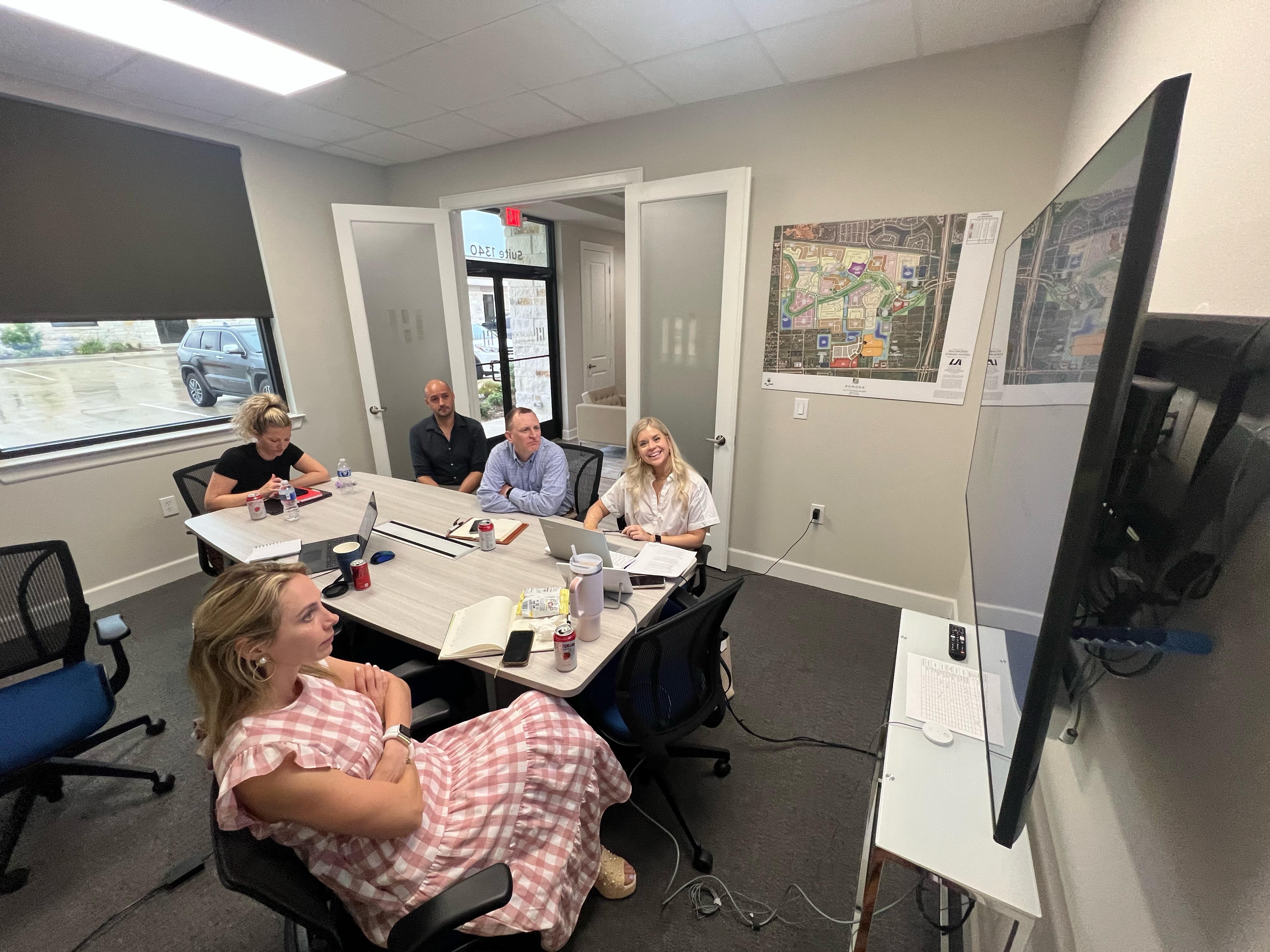 SmartTouch and Hillwood teams reviewing and discussing analytics data in the new Hillwood office building.