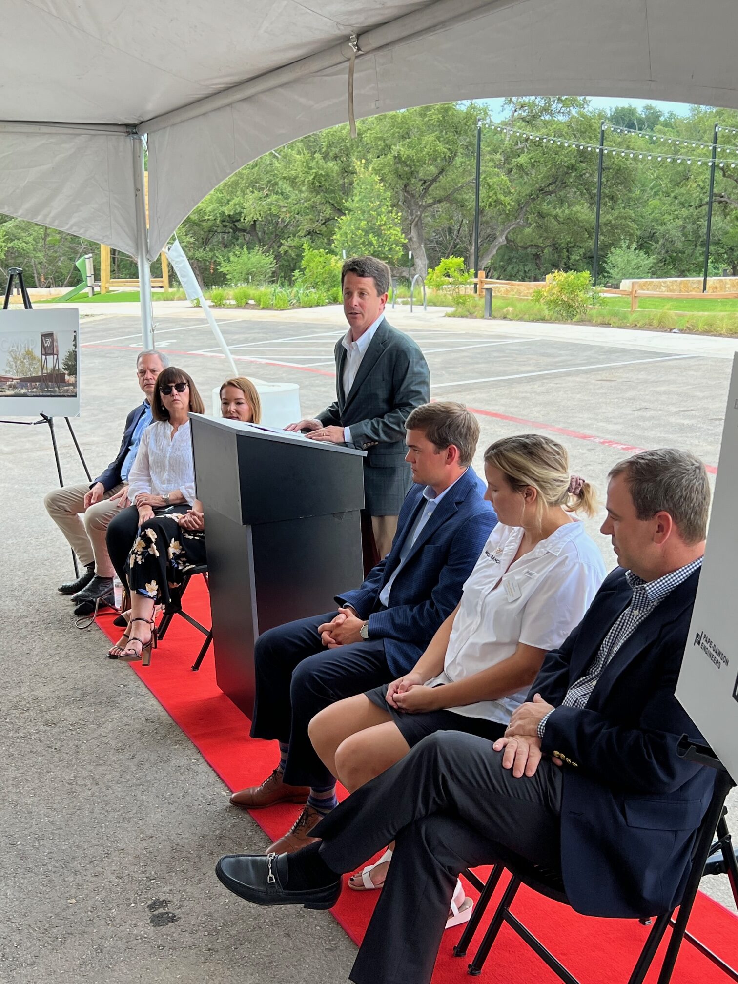 Wolf Ranch leadership presenting a speech behind a podium to announce new amenity opening