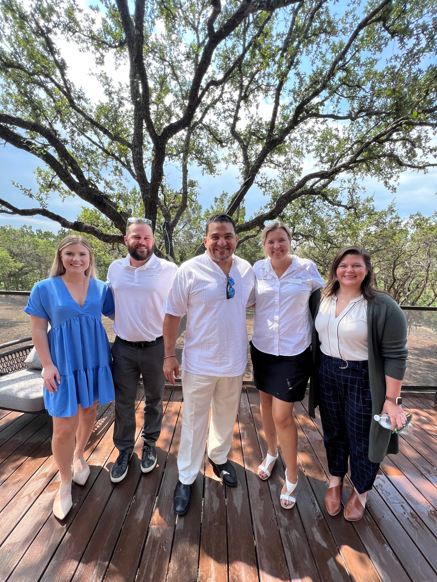 Smiling group photo of STI team during River Camp opening event 