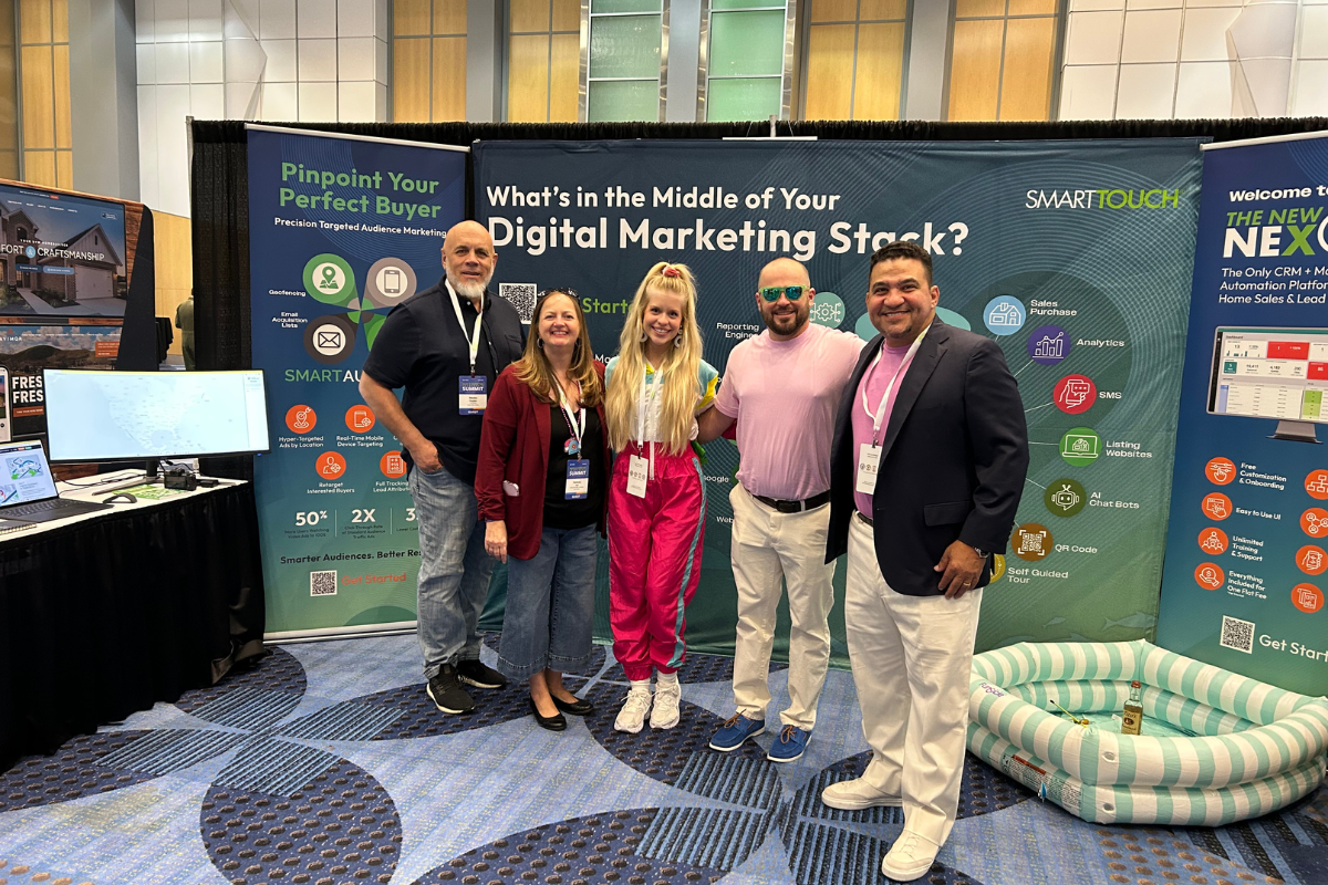 SmartTouch team standing at Booth 304 at the Summit. 