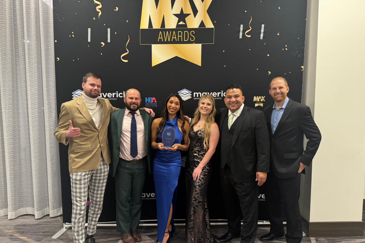 SmartTouch team posing with their MAX Award plaque. 