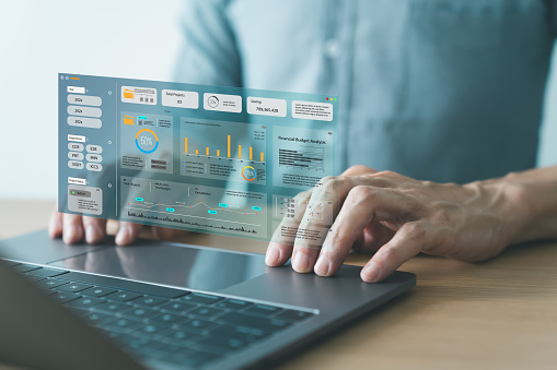 Analyst computer working with information database to analysis marketing sale data. 